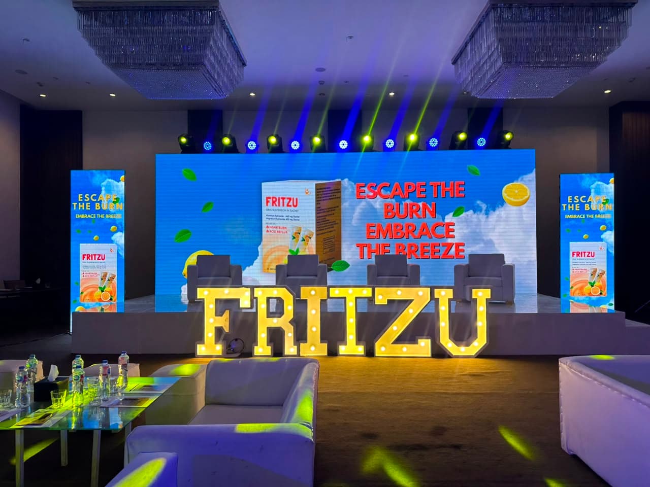 Branded FRITZU event stage with presentation seating and illuminated signage